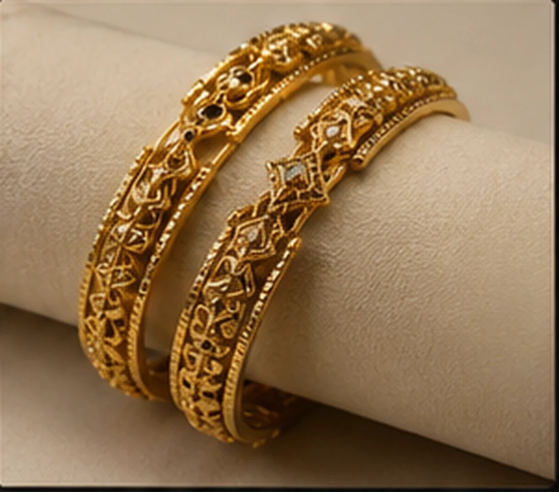 Gold bangles with detailed finishing on a cream roll